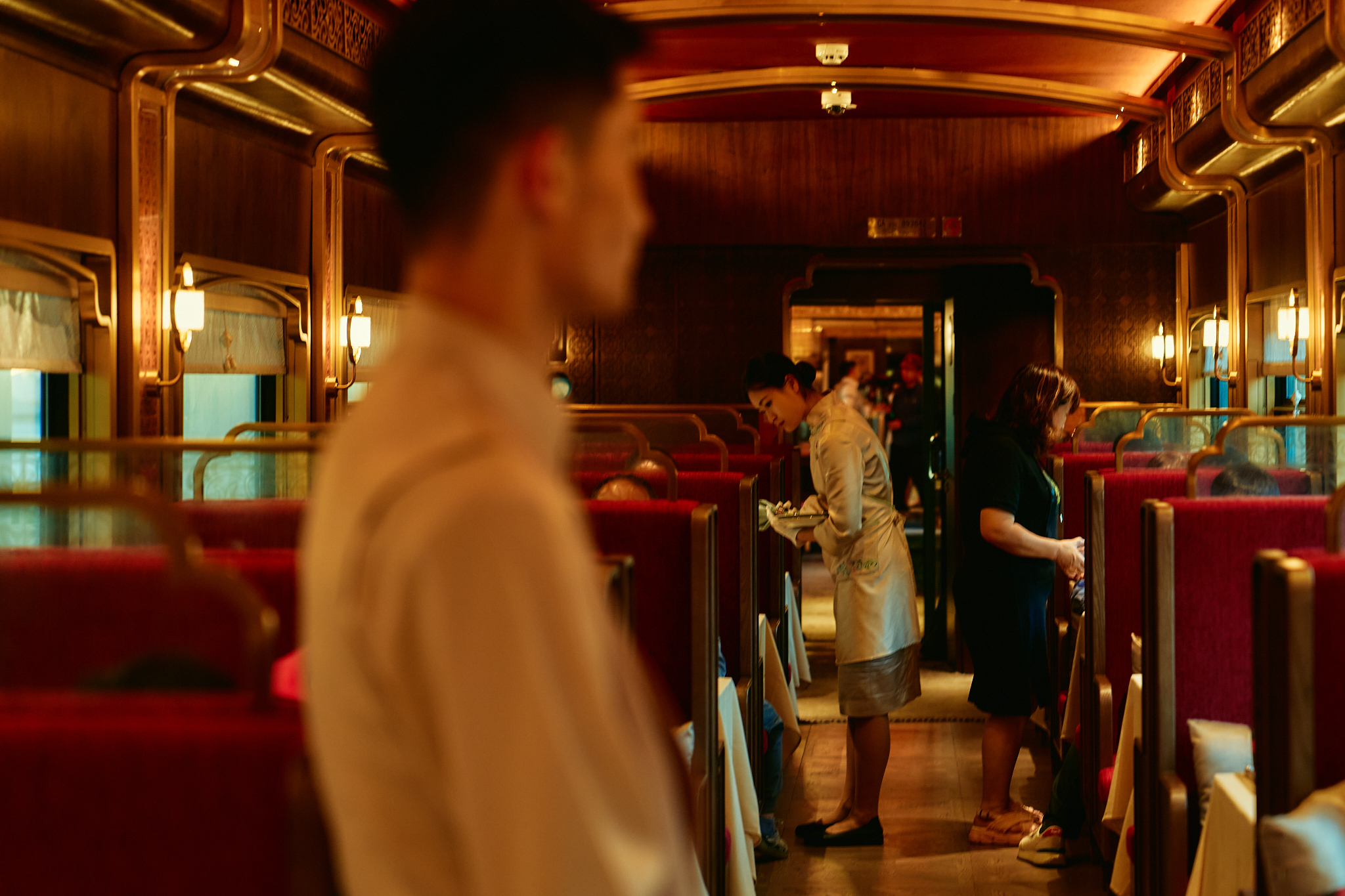 A butler serving in the lounge car