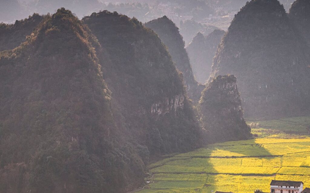 The karst peaks of Wanfenglin rising above farmland at Xingyi, Guizhou