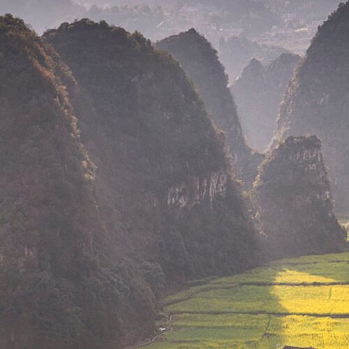 The karst peaks of Wanfenglin rising above farmland at Xingyi, Guizhou