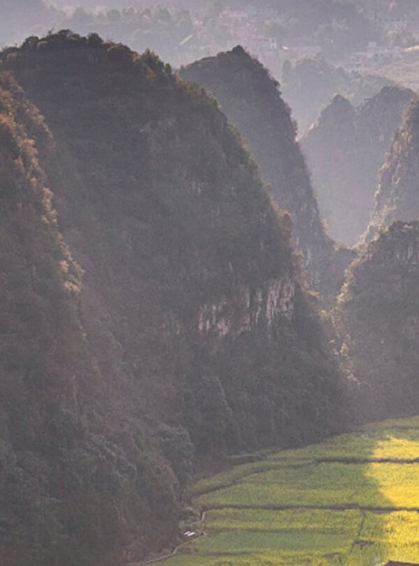 The karst peaks of Wanfenglin rising above farmland at Xingyi, Guizhou